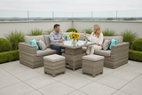 Two people sitting on a patio set with a table and chairs, enjoying a sunny day.