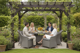 People sitting around a table under a pergola in a garden setting