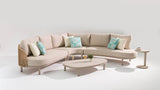 Beige sectional sofa with decorative pillows on a white background