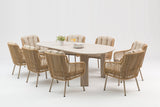 Round outdoor dining table with eight wicker chairs on a white background