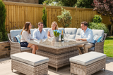 Family sitting around a patio table in a garden setting