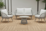 Outdoor furniture set with white cushions on a wooden deck